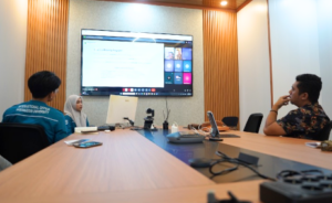 Team meeting in modern conference room with screen