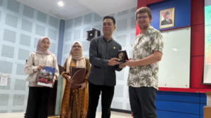 Man receiving award plaque in presentation ceremony