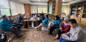 Team meeting in modern office with laptops