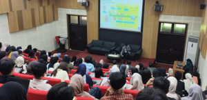 University lecture hall with speaker and presentation screen