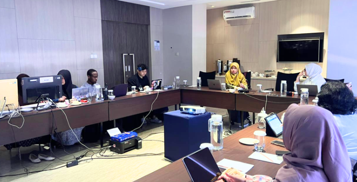 Team meeting with laptops in conference room