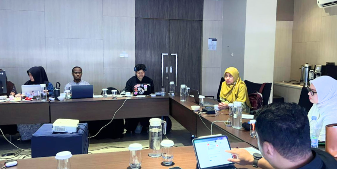 Team meeting around conference table with laptops