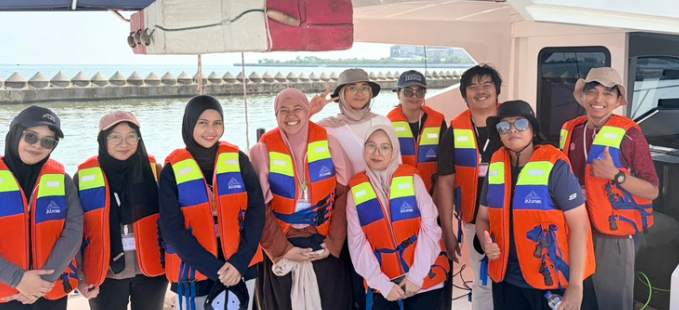 Group wearing life jackets on boat smiling