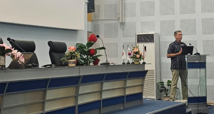Man speaking at podium in conference hall