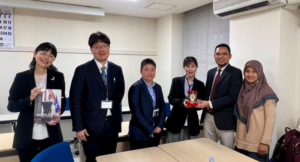 Six professionals exchanging plaque in meeting room