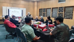 Team meeting in conference room with presentation screen