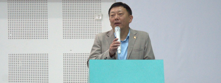 Man speaking at podium with microphone