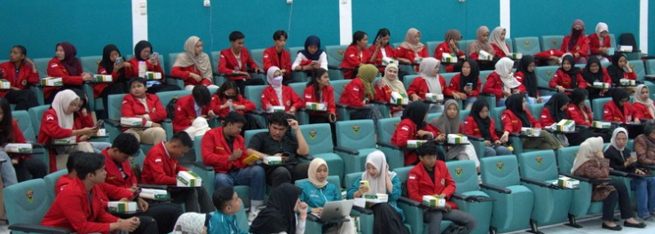 Students in red jackets seated in lecture hall