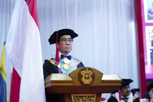 Pejabat berpidato di podium acara wisuda resmi