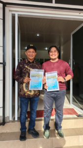 Two men holding certificates at doorway