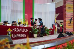 Graduate receiving diploma at Hasanuddin University ceremony