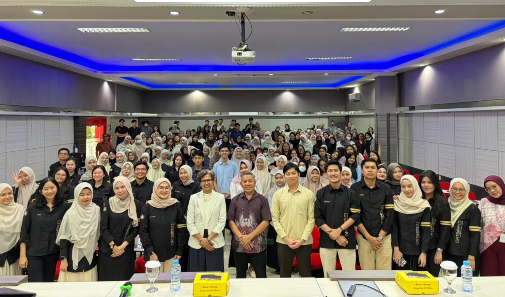 Large group photo in university lecture hall