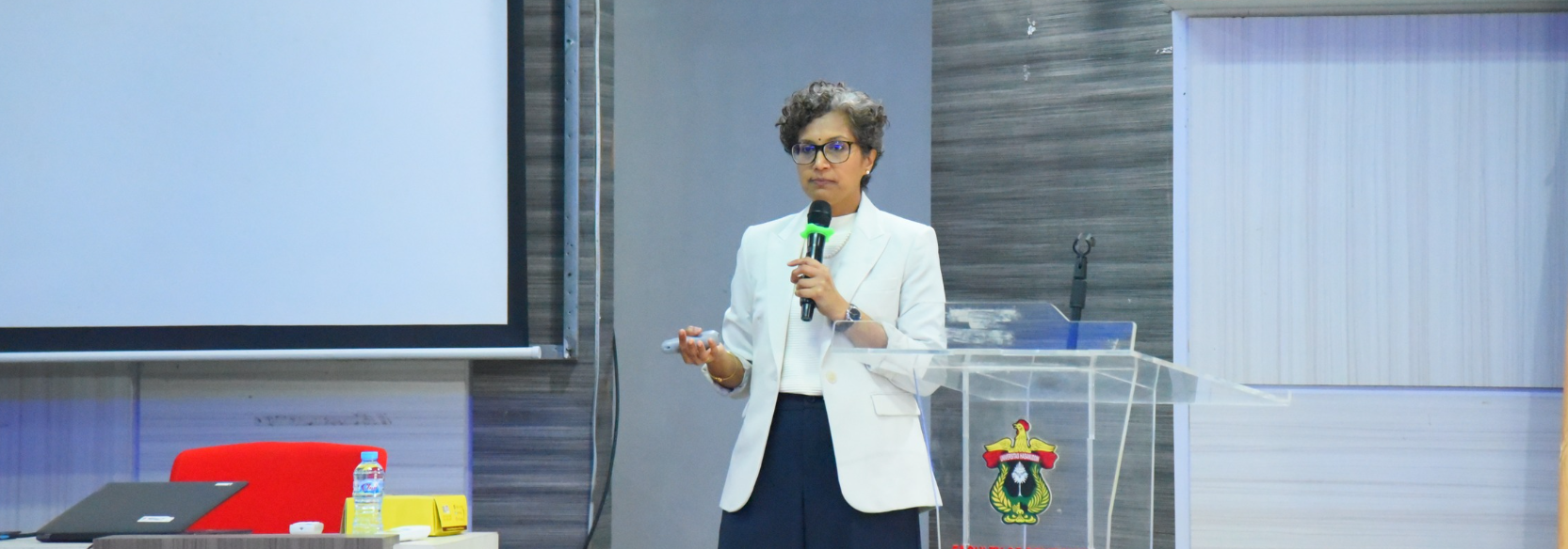 Woman giving presentation at podium with microphone