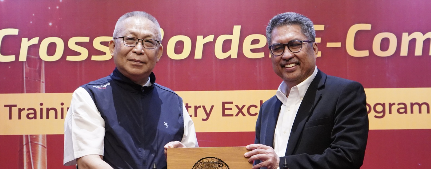 Two men holding plaque at business event