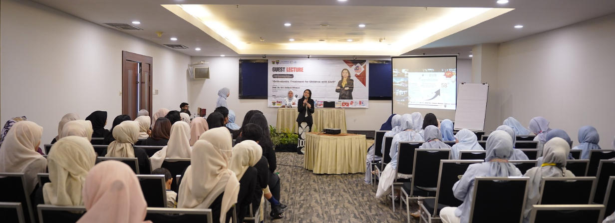 Guest lecture presentation in conference room with audience