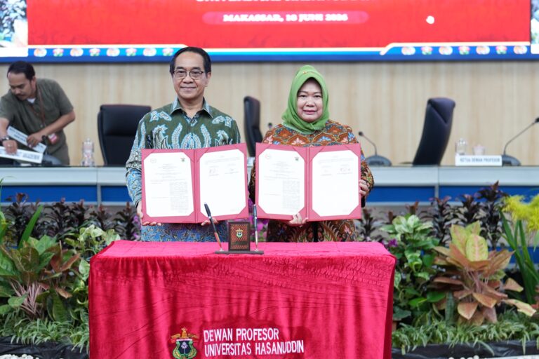 Officials display signed documents at university ceremony