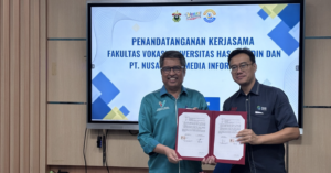 Two men holding signed partnership agreement document