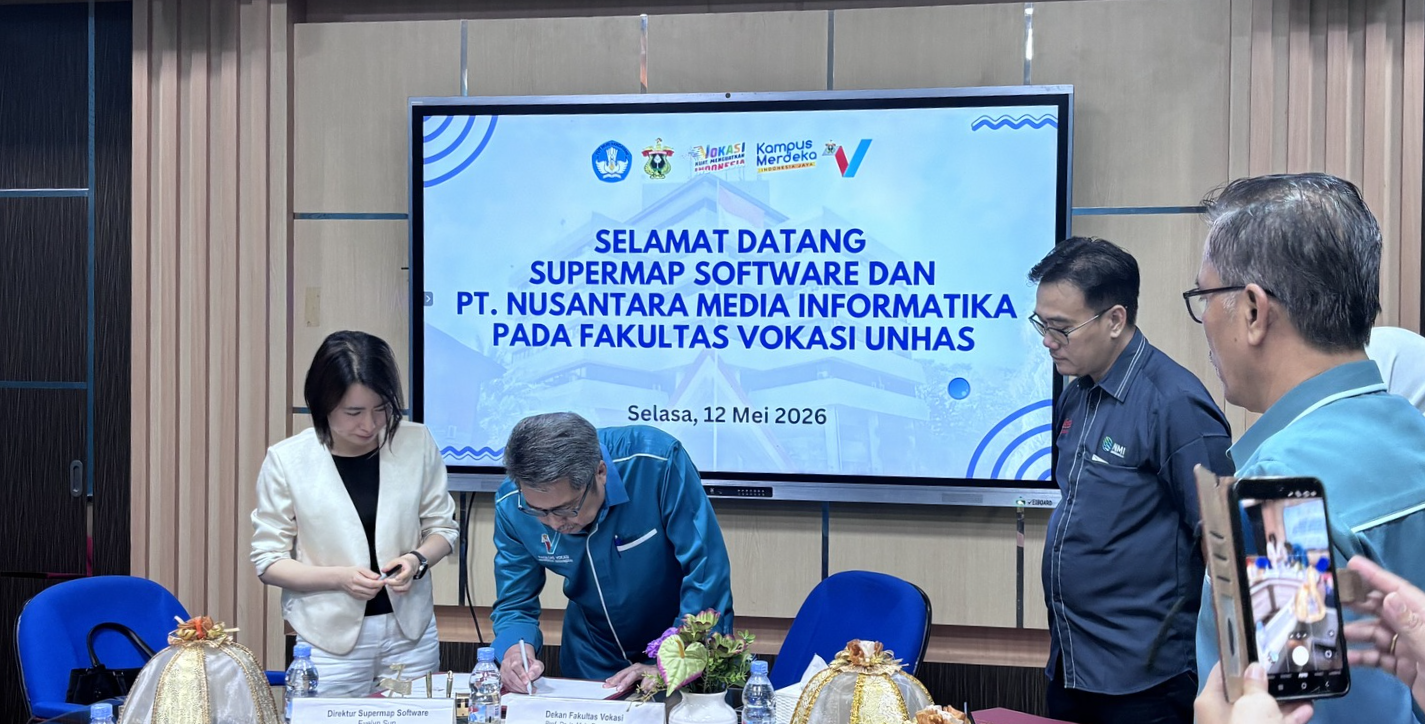 Signing ceremony at university meeting with presentation screen