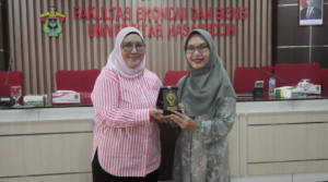 Two women holding award at university event
