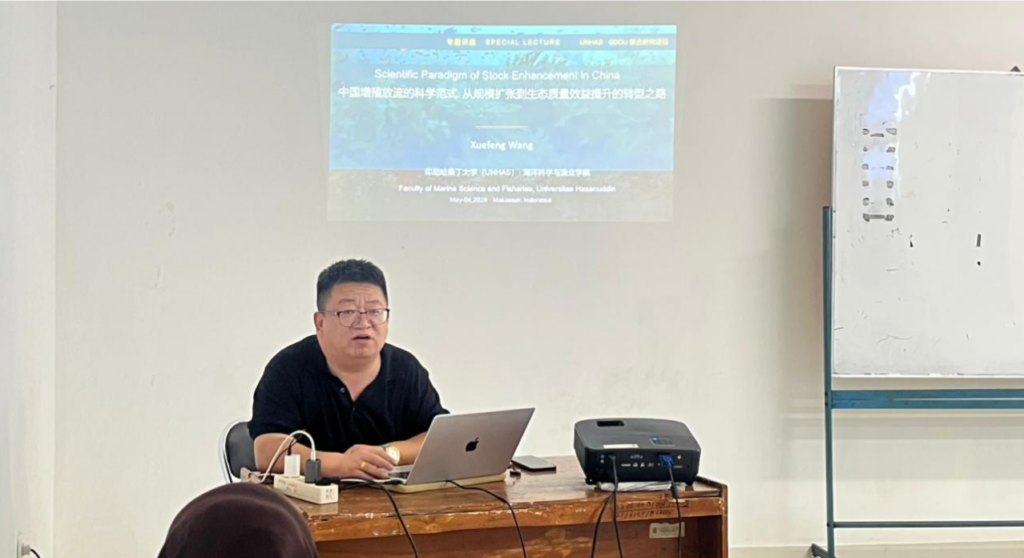 Professor presenting lecture with projected slide in classroom