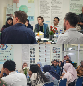 Group discussion in conference room with posters