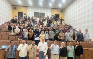 Large group of students posing in lecture hall
