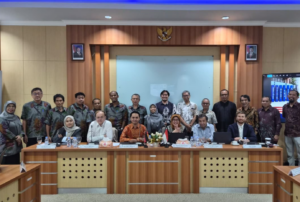 Large group at formal meeting in conference room