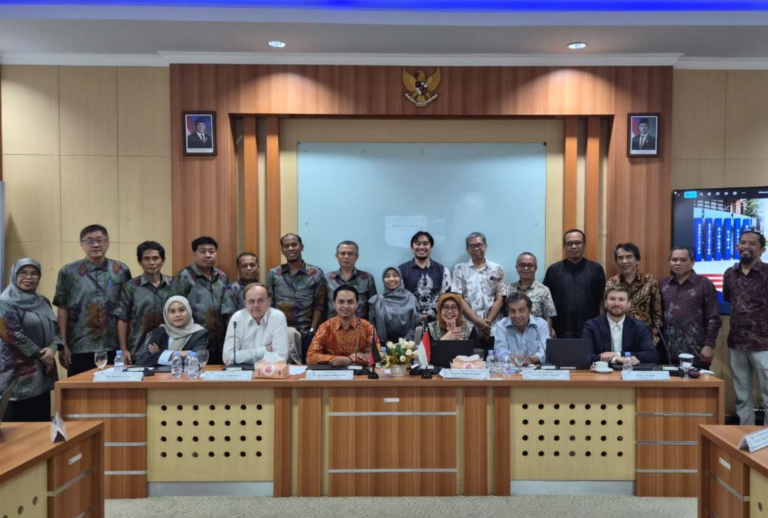 Large group at formal meeting in conference room