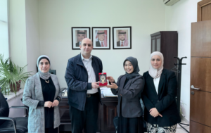 Four colleagues presenting award in office setting