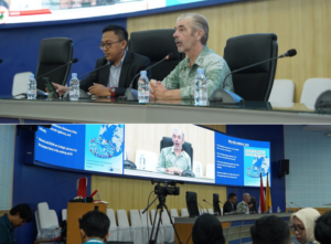 Panel discussion at conference with large presentation screen
