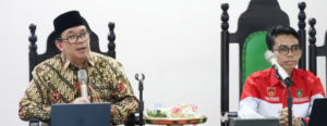 Two men speaking at formal meeting table