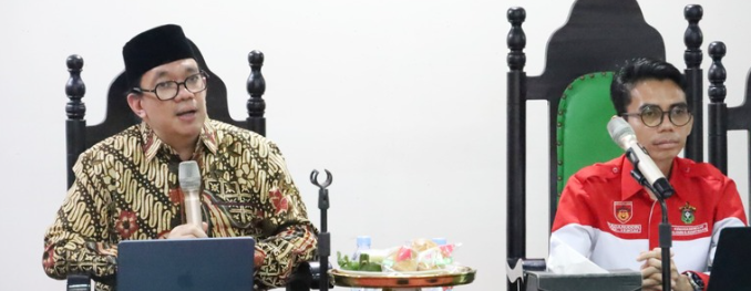 Two men speaking at formal meeting table
