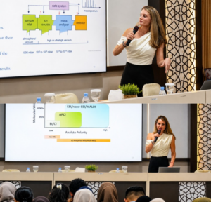 Woman presenting mass spectrometry slides at conference