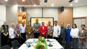 Group photo of professionals in conference room