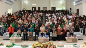Large group posing in auditorium during formal event