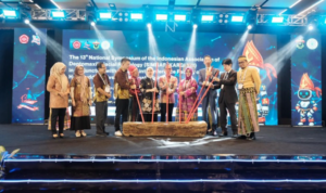 Officials perform ceremonial log lighting on stage
