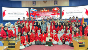 Students in red jackets at international KKN ceremony