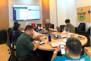 Team meeting in modern conference room with laptops