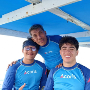 Three men in blue rash guards on boat