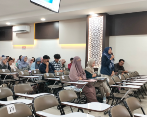 Student speaking into microphone in classroom lecture hall