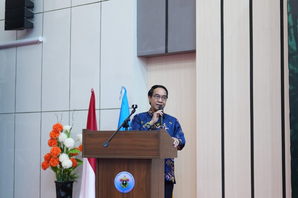Man speaking at podium during formal indoor event