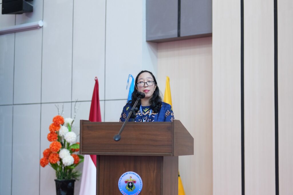 Woman speaking at podium during formal event