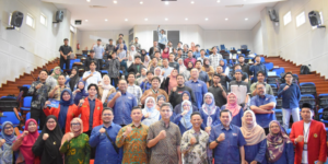 Large group posing in lecture hall auditorium