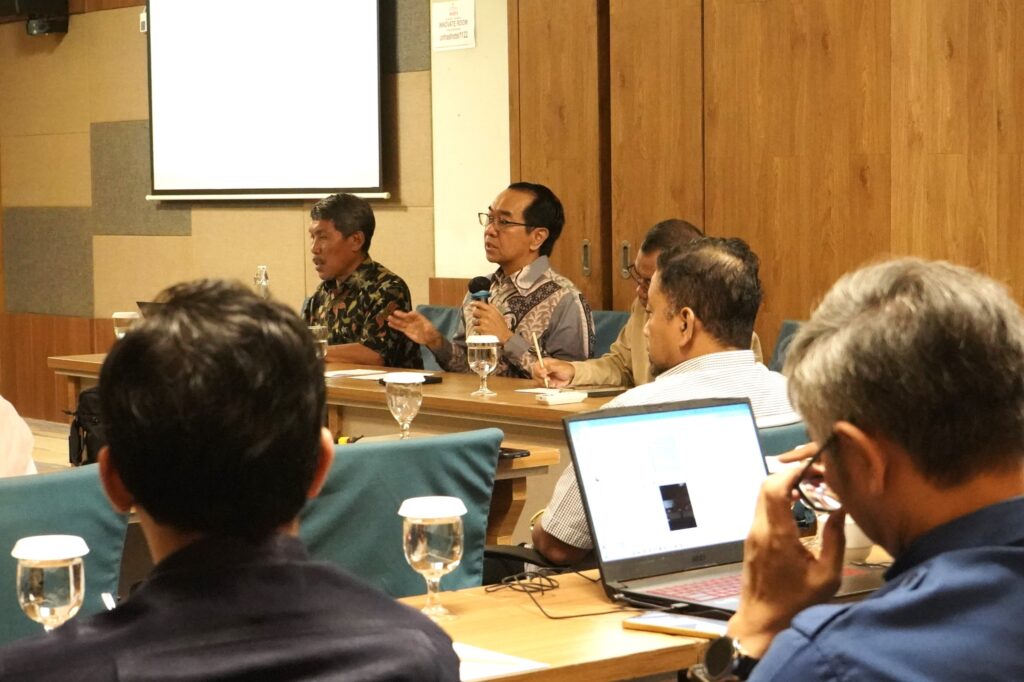 Man speaking at conference panel discussion
