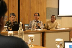 Panelists speaking at conference table with microphones