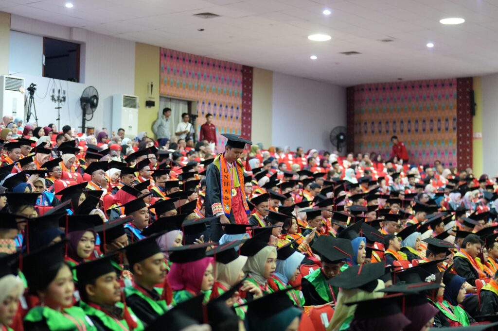 University graduation ceremony in crowded auditorium