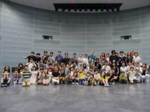 Large group of children and adults posing indoors