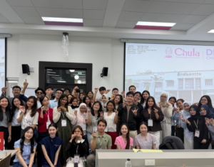 Students pose together in a university classroom