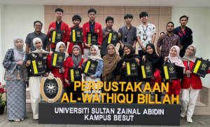 Group of students holding certificates at university library