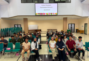 Students seated in lecture hall under presentation screen